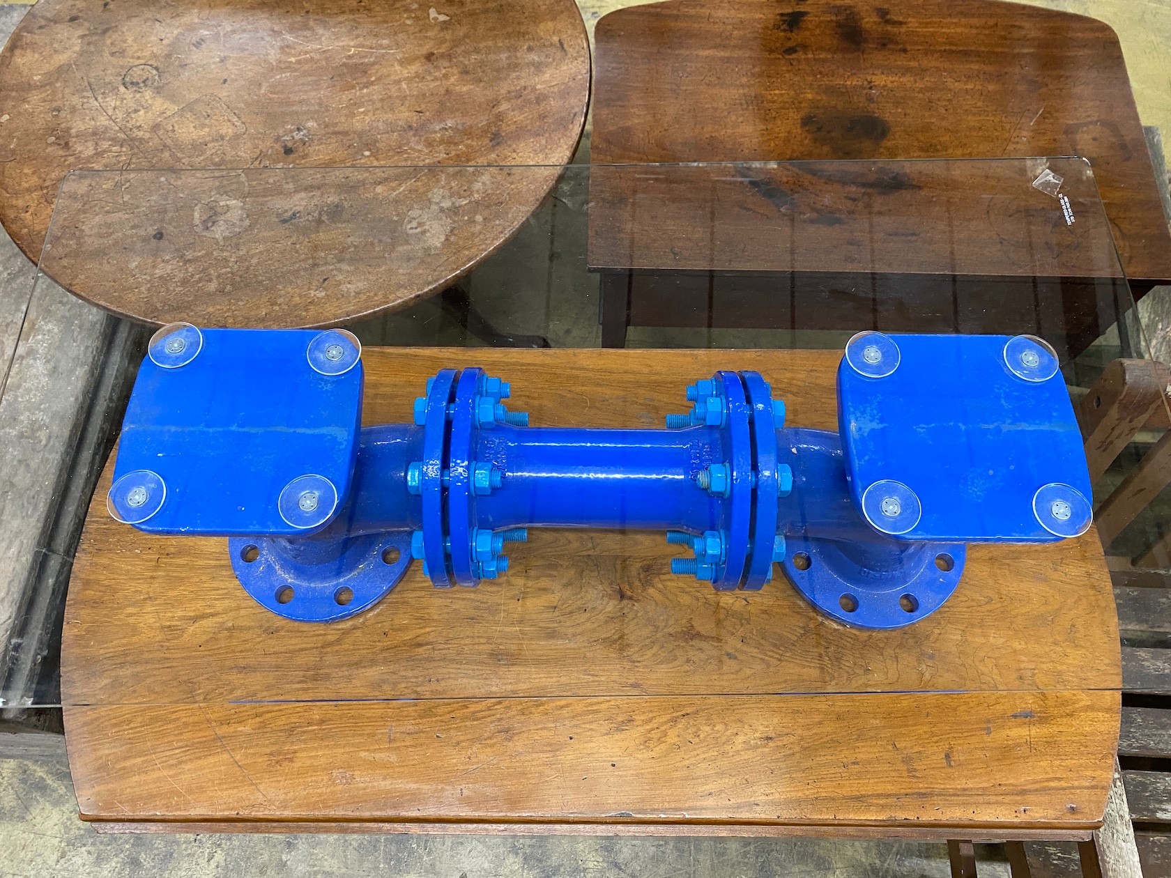 An industrial style cast iron steam pump glass top coffee table, length 93cm, width 48cm, height 29cm